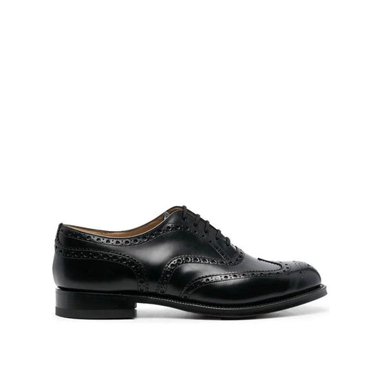Black leather brogue shoe on a white background