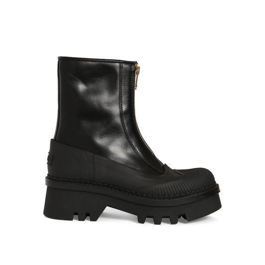 Black leather boot with a chunky sole on a white background