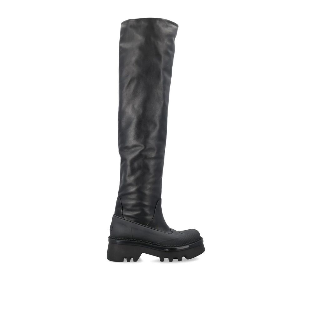 Black knee-high boot on a white background