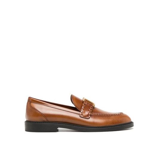 Brown loafer shoe on a white background